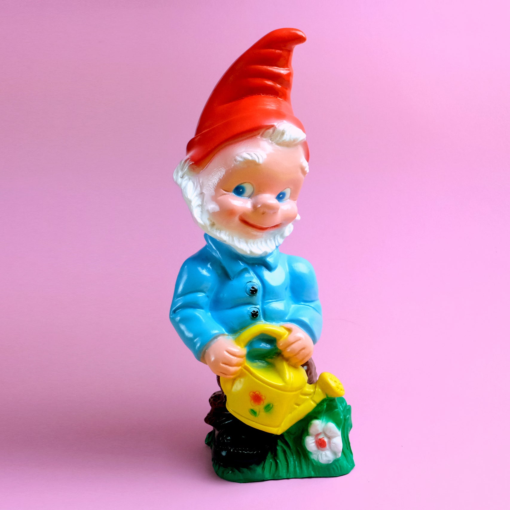 Garden gnome with yellow watering pot