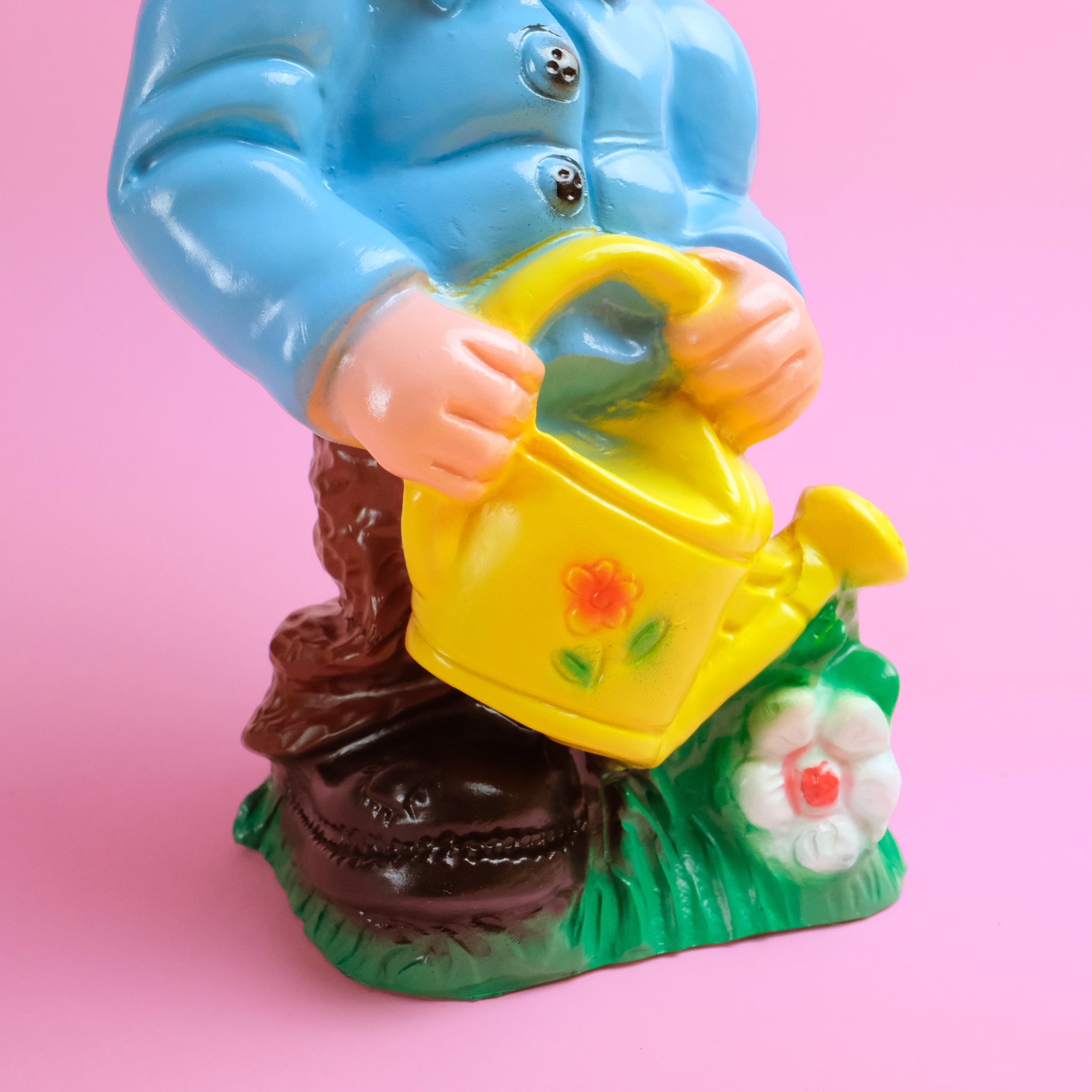 Garden gnome with yellow watering pot